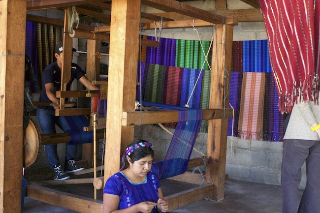 Weaving by loom and by hand at a studio in San Antonio, Guatemala