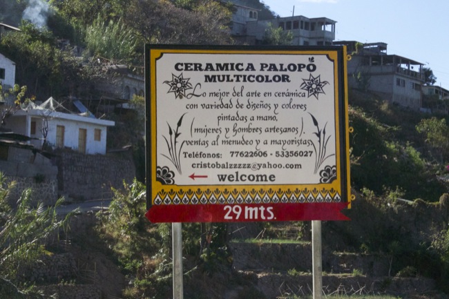 A sign on the road for a ceramics studio and shop