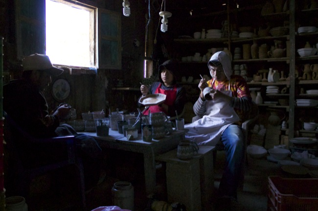 Ceramics at work painting and finishing pieces