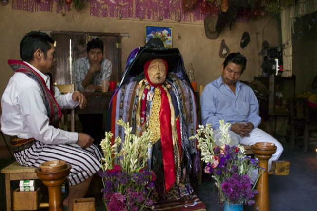 Two people usually sit with Maximón all day and night, accepting offerings from believers and visitors alike. We paid about 5 quetzales (75 cents) each to get in, and then I paid about 10 quetzales ($1.25) to take photos.
