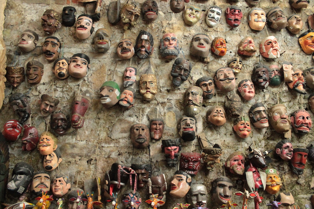 Wall of Masks hanging at a store called Nim Po't in Antingua, Guatemala